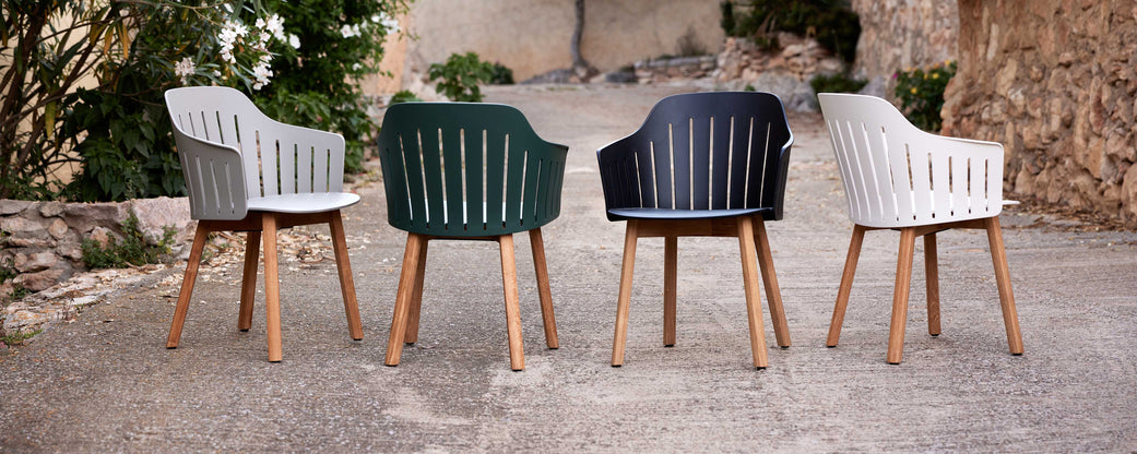 A selection of four colorful chairs with wooden legs, showcasing modern design and varying shades of gray, black, and green.