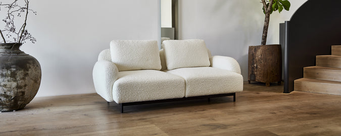 Modern white sofa in a contemporary lounge setting.