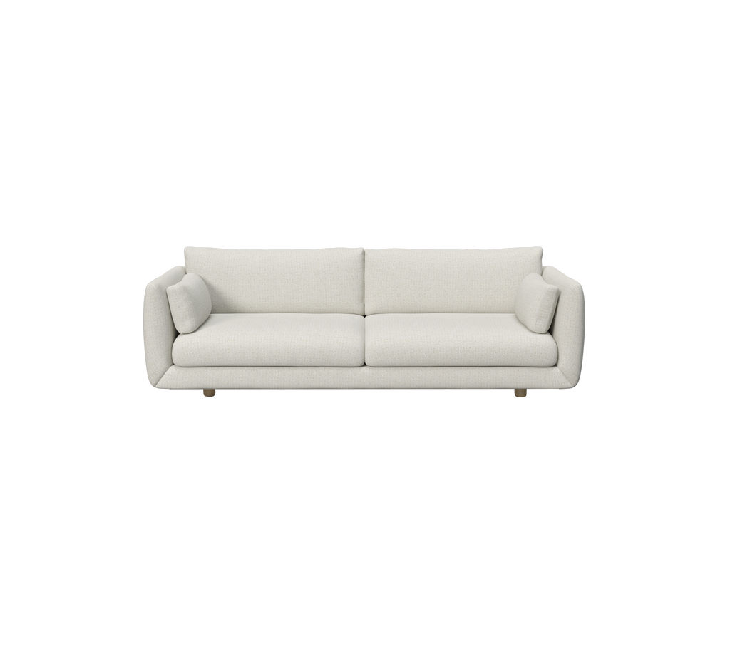 Modern sand-colored sofa with round cushions.
