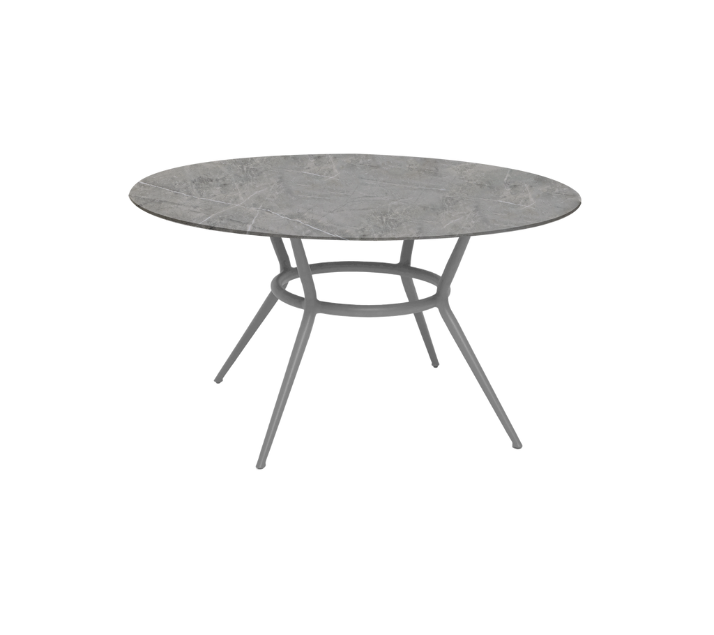 Round light grey table with a minimalist design.