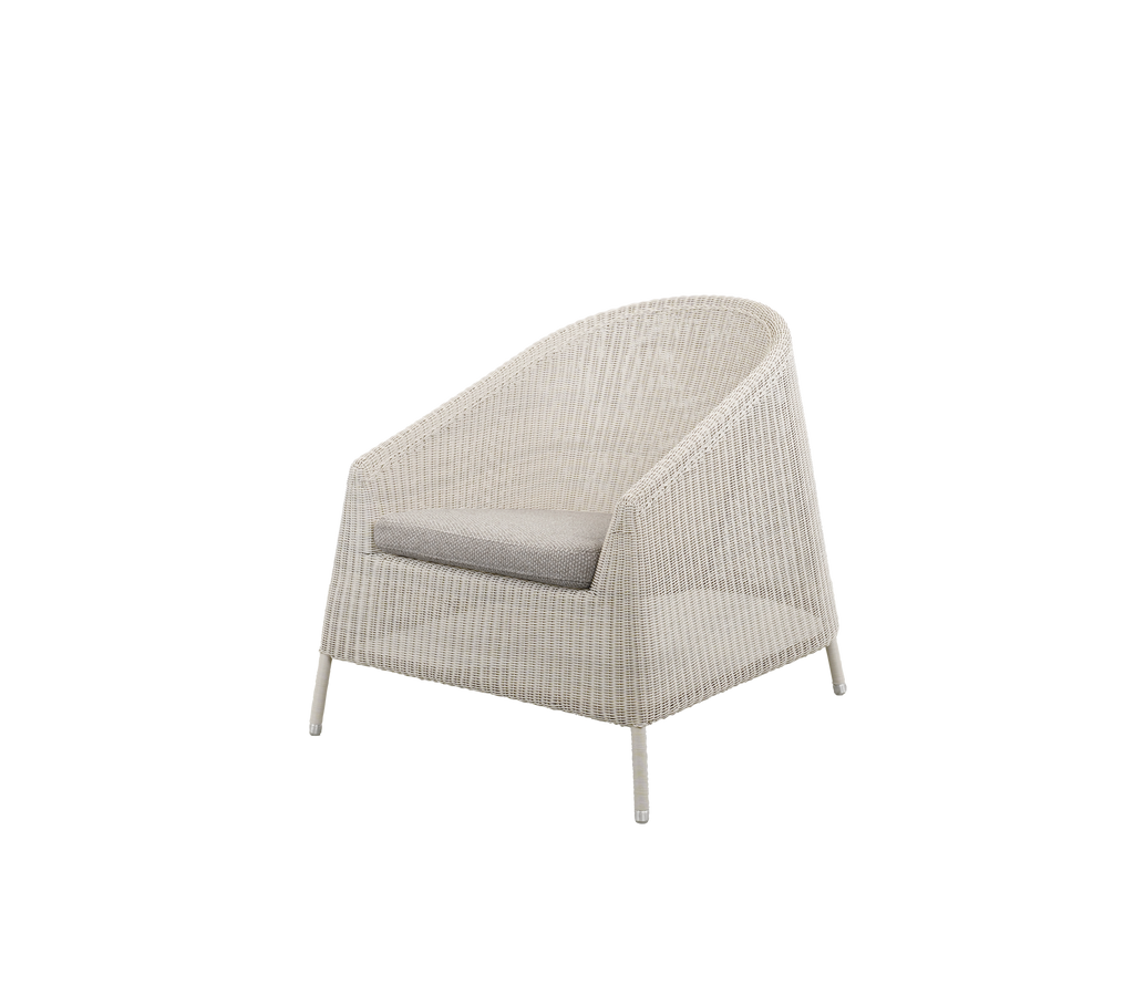 Modern chair with a light brown cushion in a cozy setting.