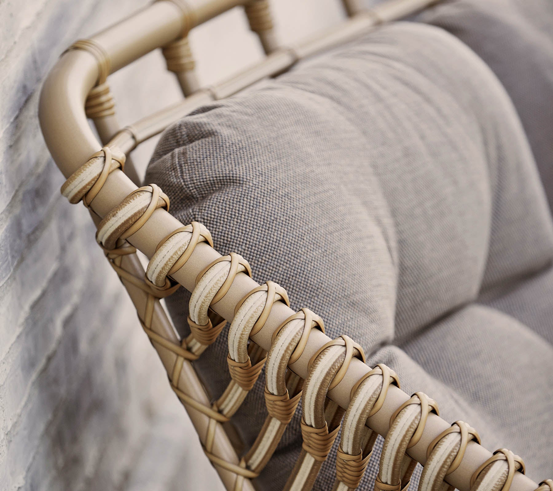 Stylish seating option featuring a beige woven frame and soft gray cushions, perfect for enhancing modern decor.