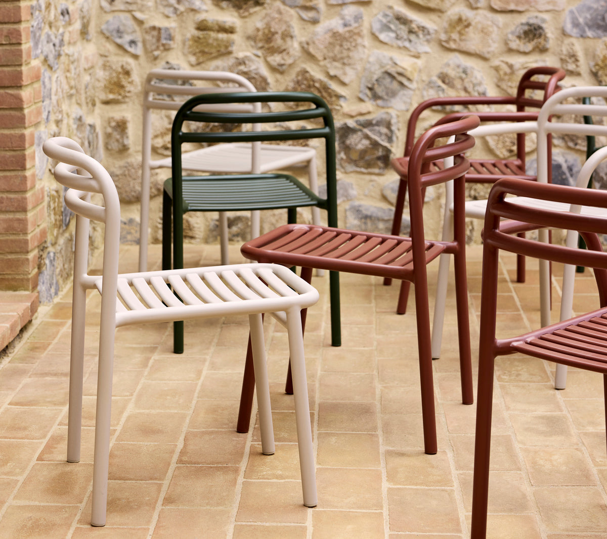 A collection of colorful Bliss chairs in various shades, showcasing a modern, minimalist design with slatted seats and curved backrests.