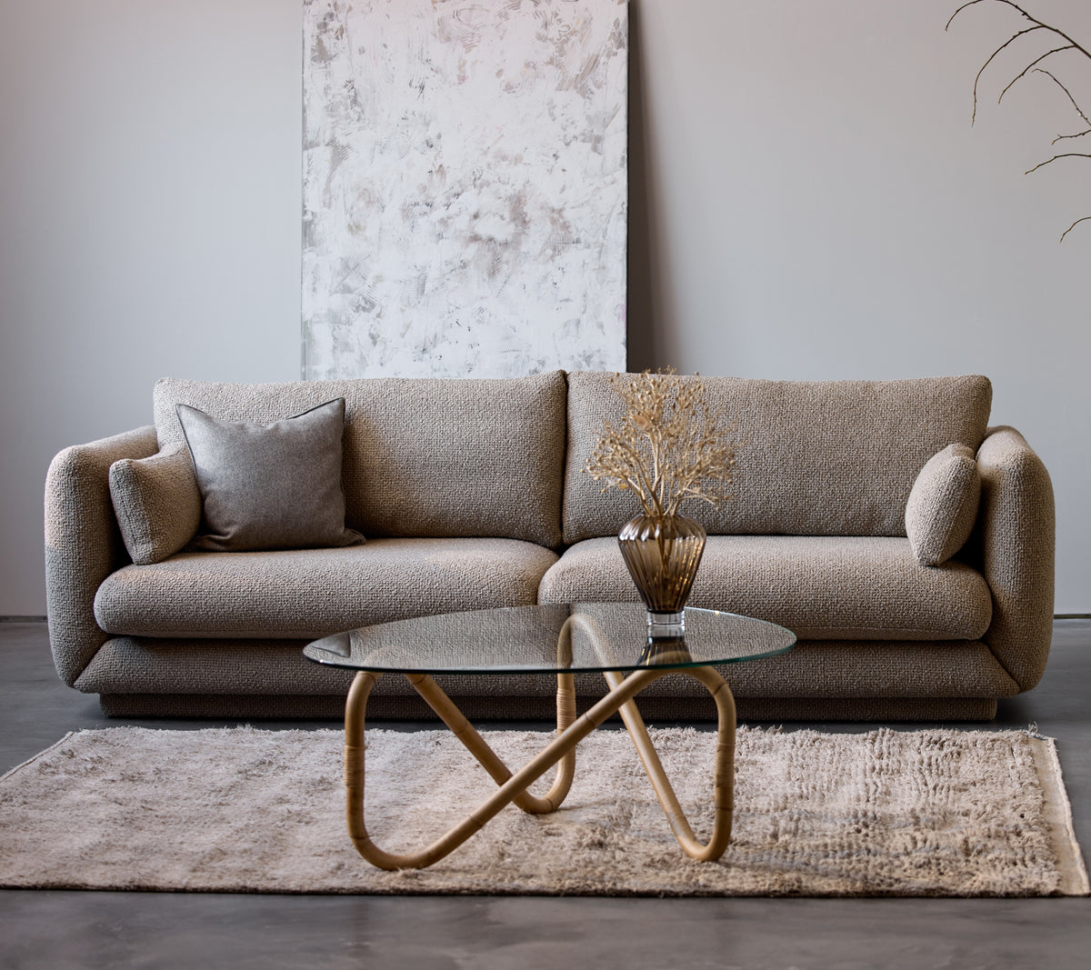 Bloom 3-seater sofa in taupe flair with a plinth, paired with a Wave indoor coffee table and a decorative vase, on a soft rug.