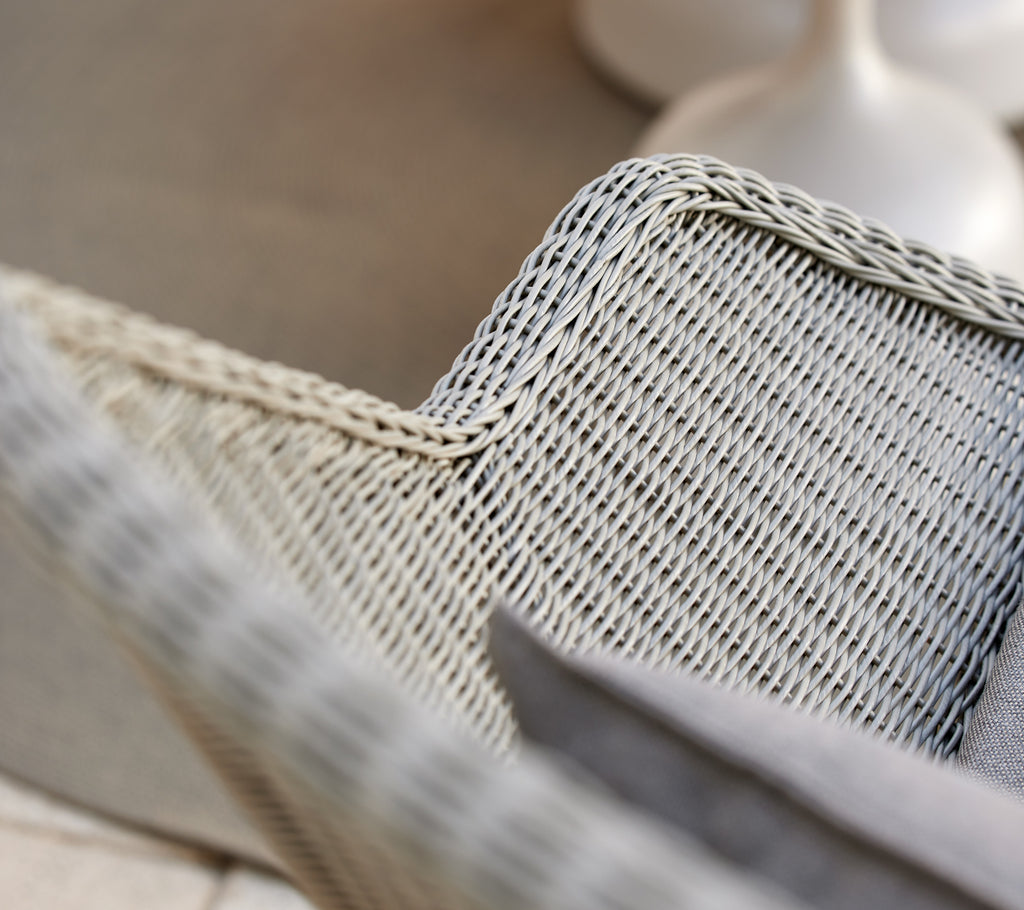 Grey woven lounge chair with a grey cushion.