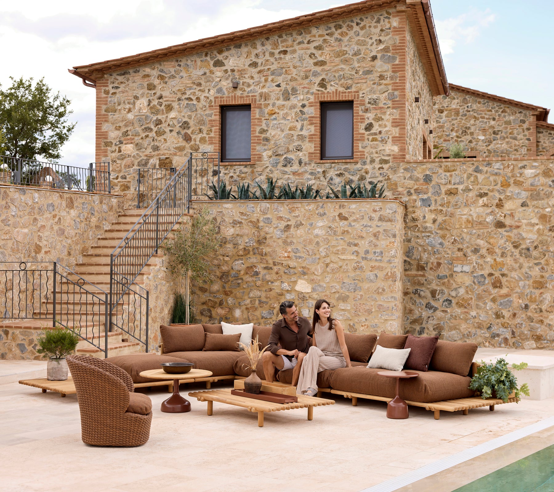 Stylish lounge area featuring teak furniture and comfortable seating, ideal for relaxing with someone special.